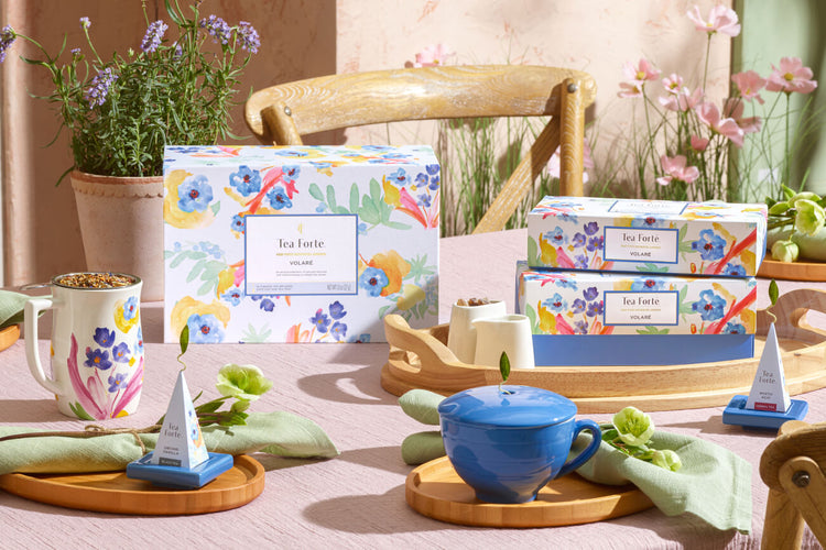 Volaré Collection cups and gift boxes on a summer table with rosemary and wildflowers