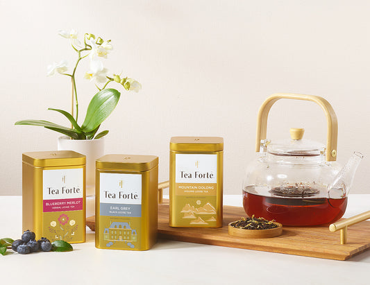 3 loose tea canisters with glass teapot