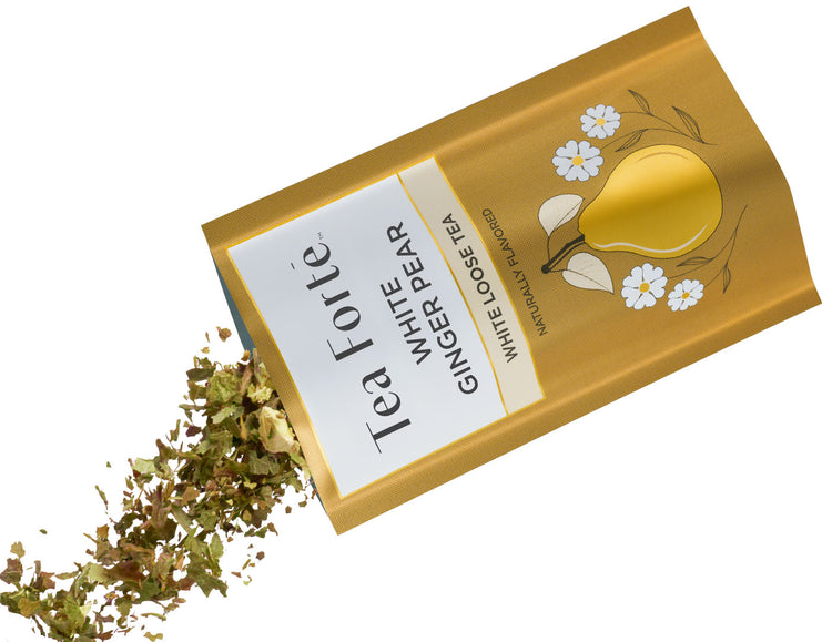 A gold foil packet of White Ginger Pear tea, shown tilted with dried tea leaves spilling out from the bottom left on a white background.