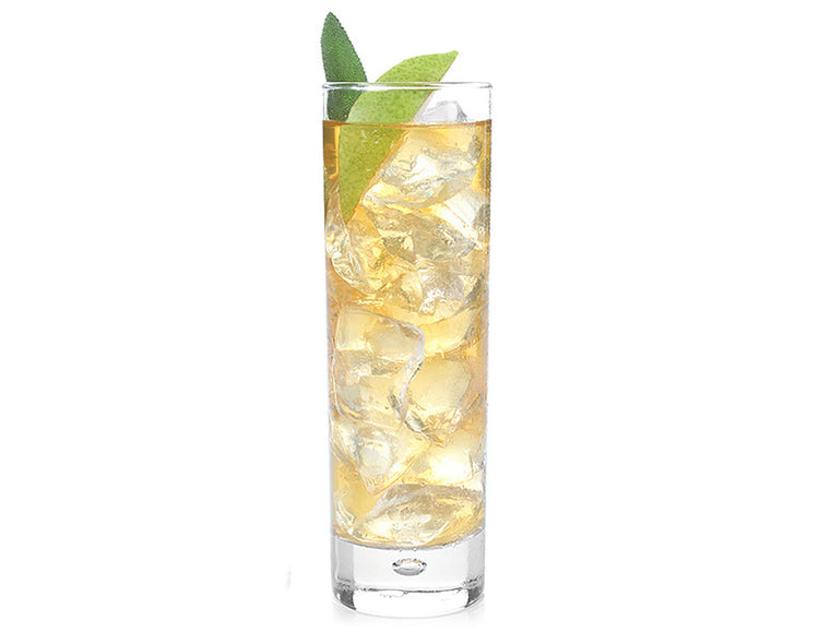 A tall clear glass filled with a Iced White Ginger Pear, large ice cubes, and two green lime slices on a plain white background.