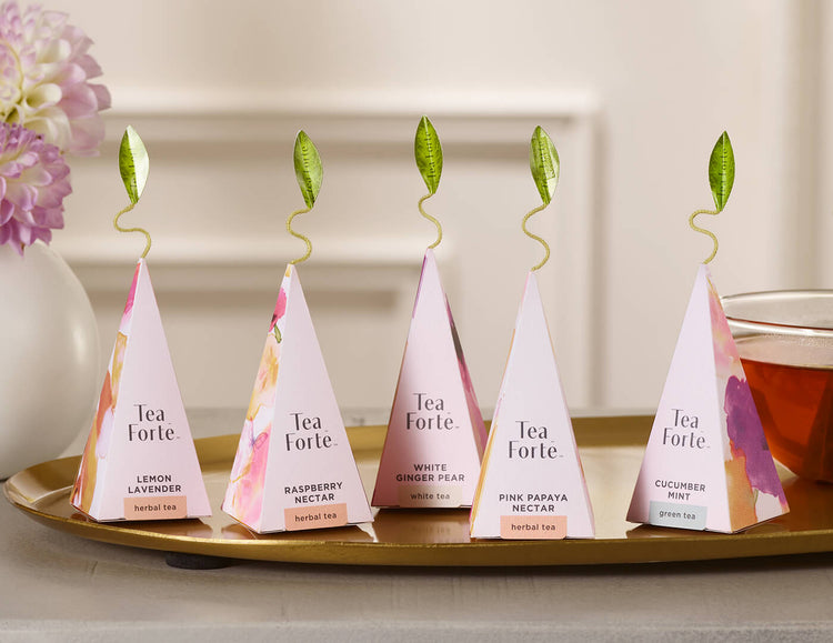 Five Mariposa pink pyramid infusers on a tray
