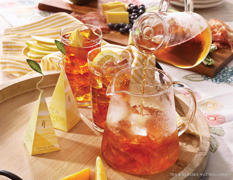 Pouring steeped Ceylon Gold tea into a Tea Over Ice Pitcher Set