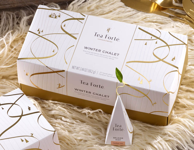 Winter Chalet presentation box of 20 pyramid tea infusers, with lid closed on a fur rug